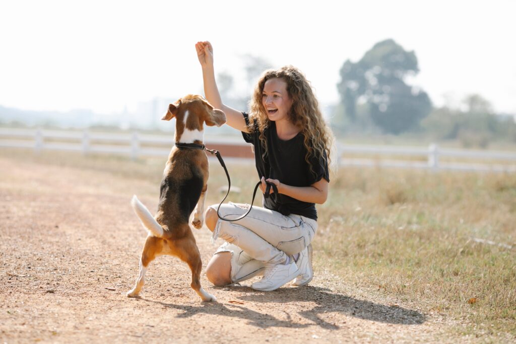 Image of a woman and her dog playing