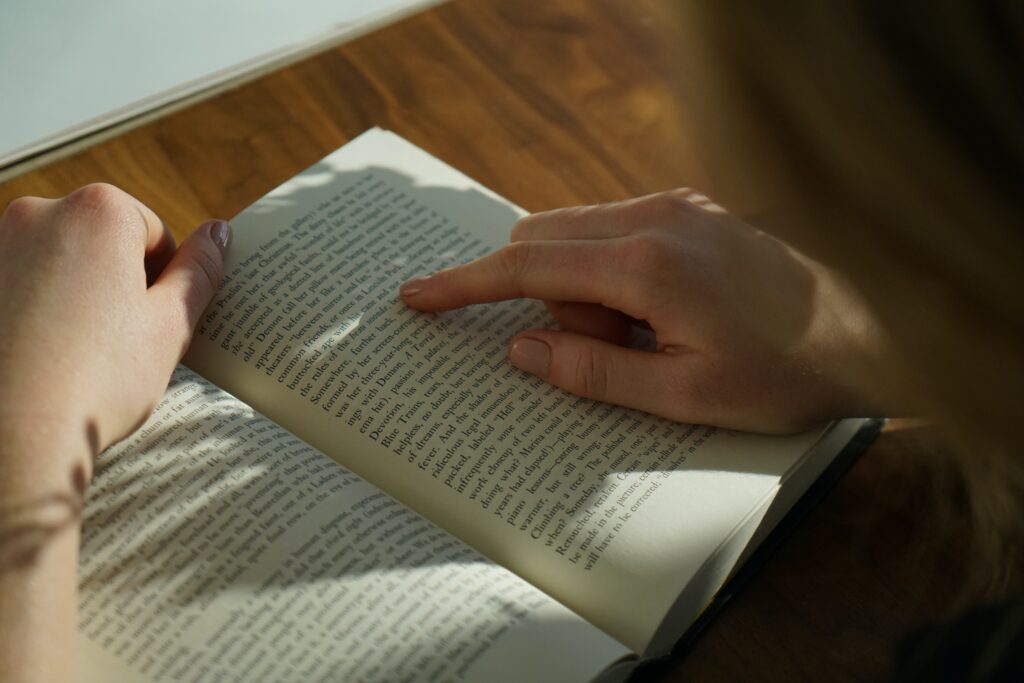 A photo of someone reading fast and following along with their finger
