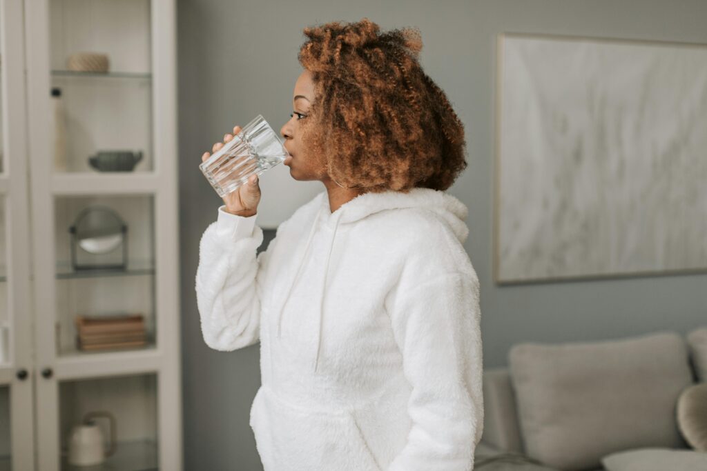 Photo of a woman hydrating as part of her morning routine checklist 